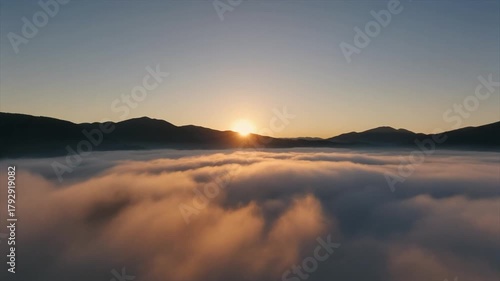 Sunrise Glow Through Mountain Fog Background
