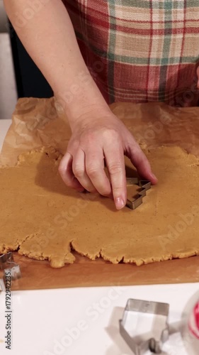 Creating traditional gingerbread cookies for Christmas is a fun and enjoyable activity. Watch as the dough is rolled out and shaped using cookie cutters for a delightful treat.