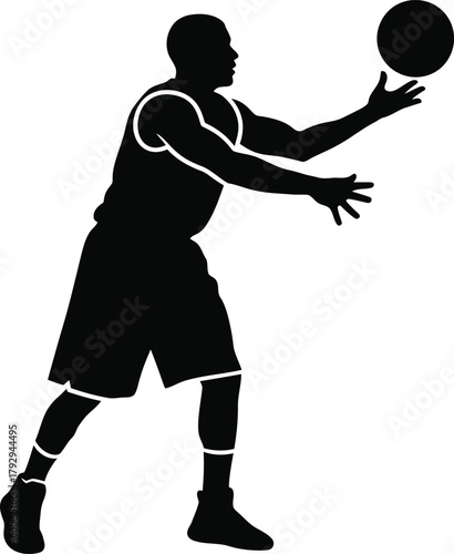 Silhouette of a basketball player dribbling the ball