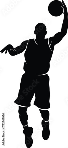 Silhouette of a basketball player dunking a ball