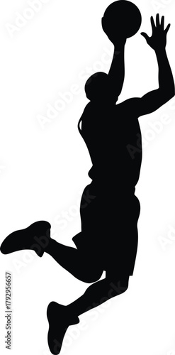 Silhouette of a basketball player mid air during a dunk