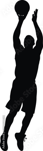 Silhouette of a basketball player in mid air shooting a ball