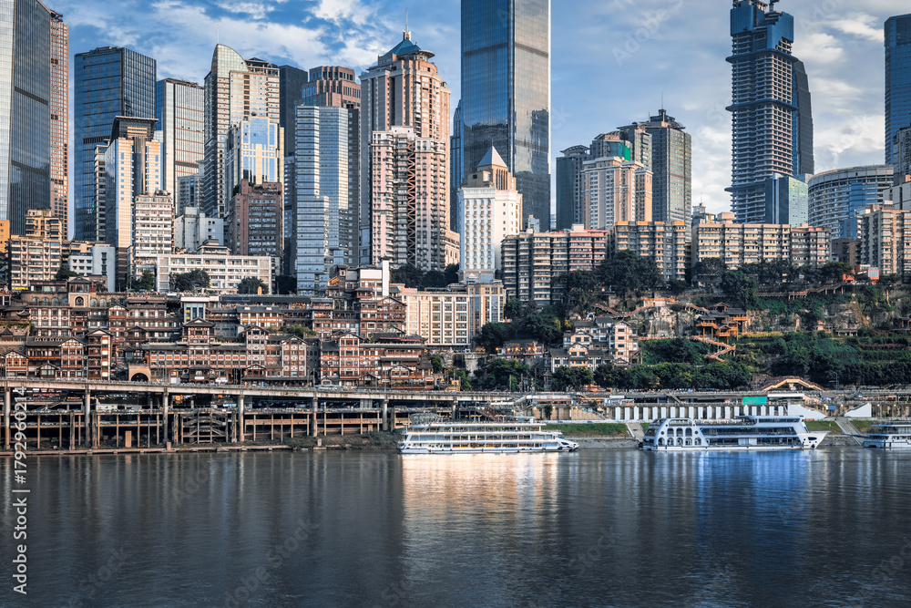 Obraz premium Dense urban cityscape and modern skyscraper skyline along the riverfront in Chongqing.