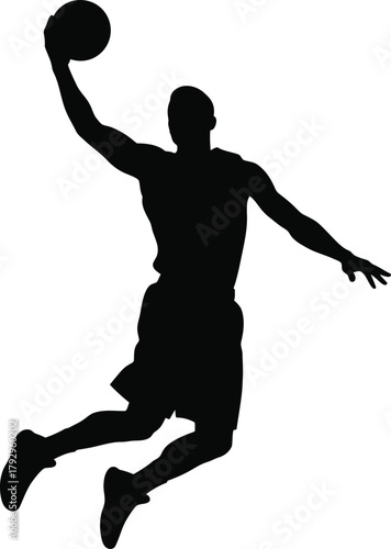 Silhouette of a basketball player dunking the ball