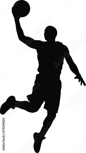 Silhouette of a basketball player in mid air during a slam dunk