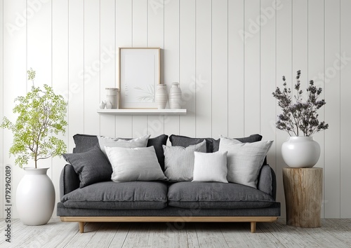 Neutral living room with gray sofa, plants, and wood flooring