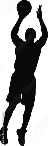 Silhouette of a basketball player shooting a ball