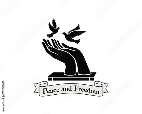Black silhouette of hands releasing two doves with peace and freedom banner