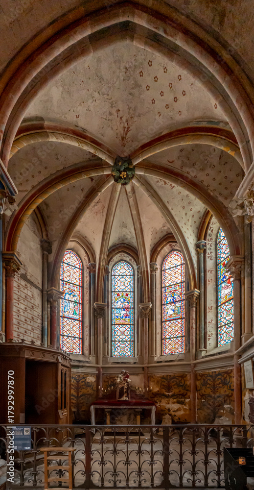 Fototapeta premium Semur-En-Auxois, France - 10 21 2025: Collegiate Church of Notre-Dame. Detail view of the Saint-Joseph chapel with painted decorations and stained glass windows restored by Viollet-Le-Duc