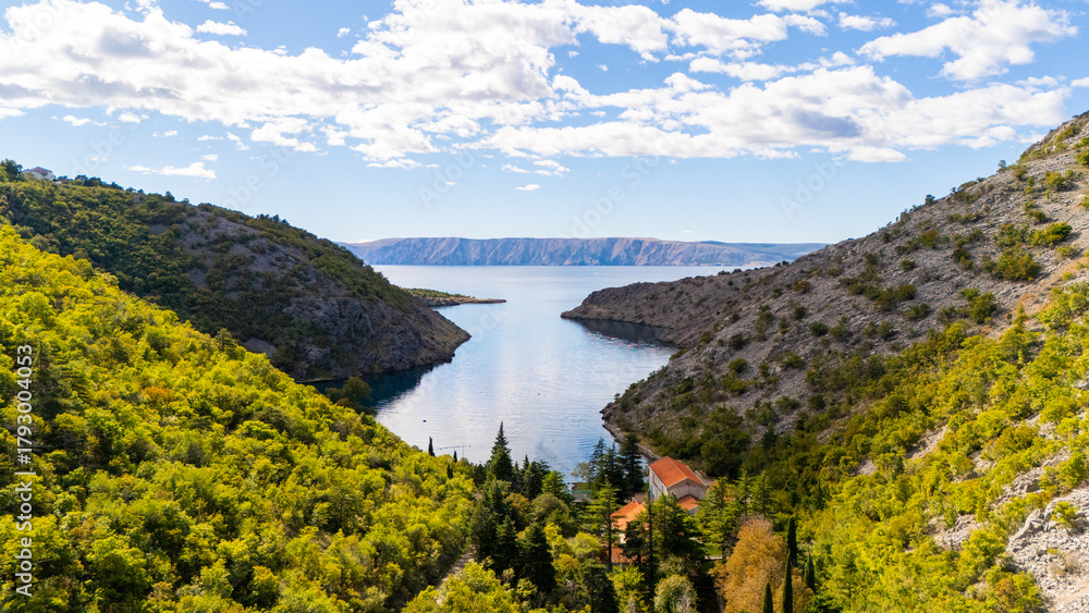 Naklejka premium Cinematic Aerial View of Croatian Landscape – Blue Adriatic Bay Surrounded by Wild Forests and Untouched Mediterranean Nature