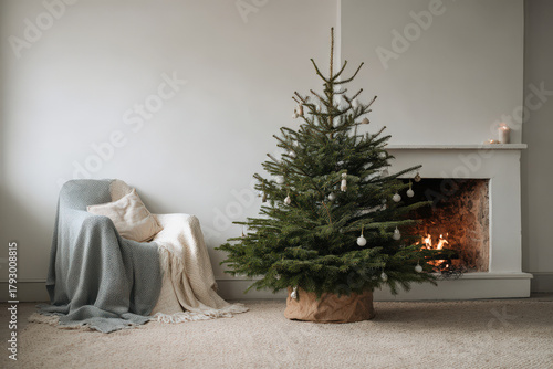 beautifully decorated christmas tree stands majestically in cozy living room beside crackling fireplace