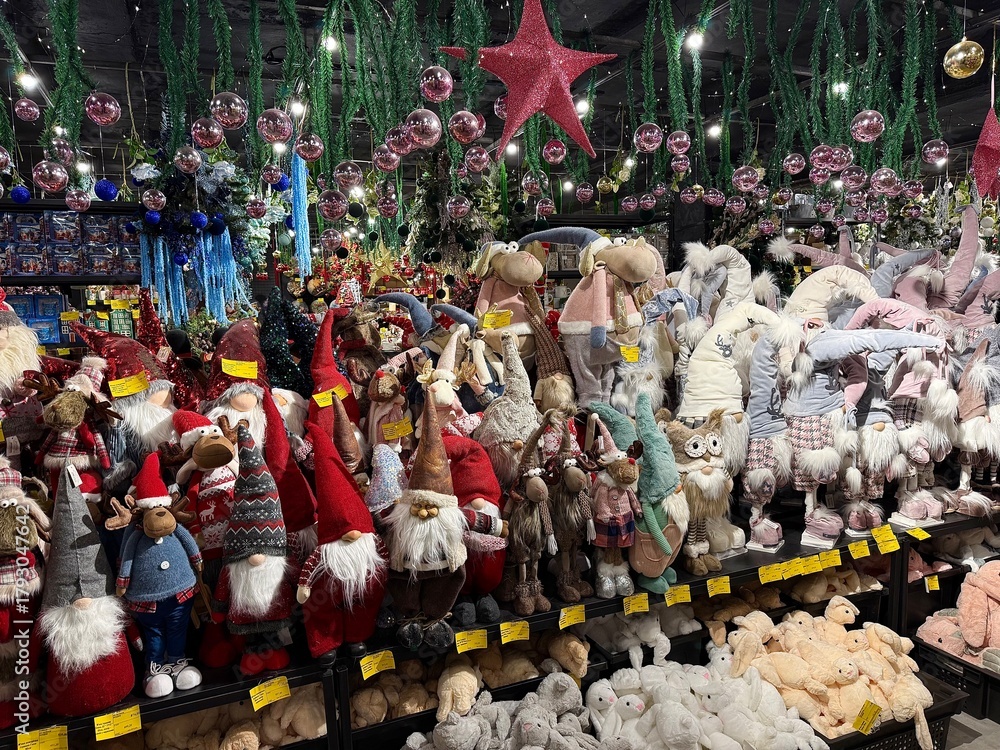 Fototapeta premium Festive store display featuring a large collection of christmas gnomes, stuffed animals, and decorative ornaments creating a cheerful holiday shopping atmosphere