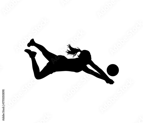 Silhouette of a female volleyball player diving to hit the ball during a competitive match