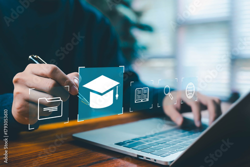 A person selecting digital education icons on a laptop, featuring an online learning platform, graduation cap symbol, study materials, research tools, and modern e-learning technology for development.