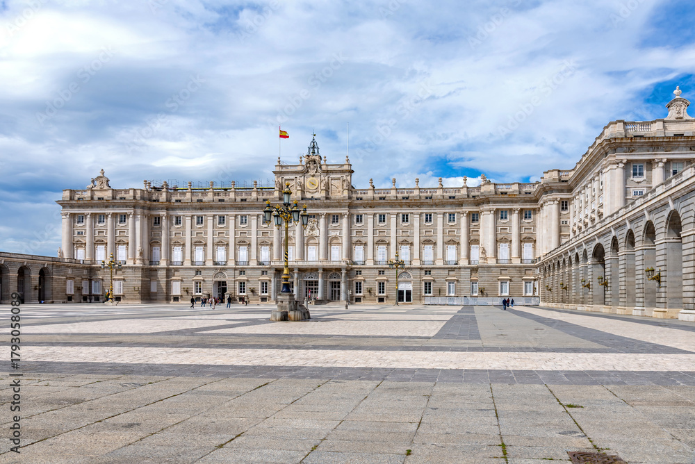 Obraz premium Majestic view of Madrid’s Royal Palace, captured from a medium distance, showcasing its grand façade, elegant symmetry, and regal architectural detail, subtle charm