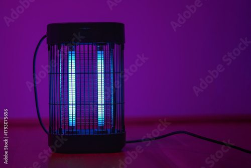 Photos Electric insect killer lamp glowing in purple light