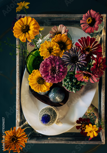 Overhead informal floral tray arrangement with zinnias and succulents