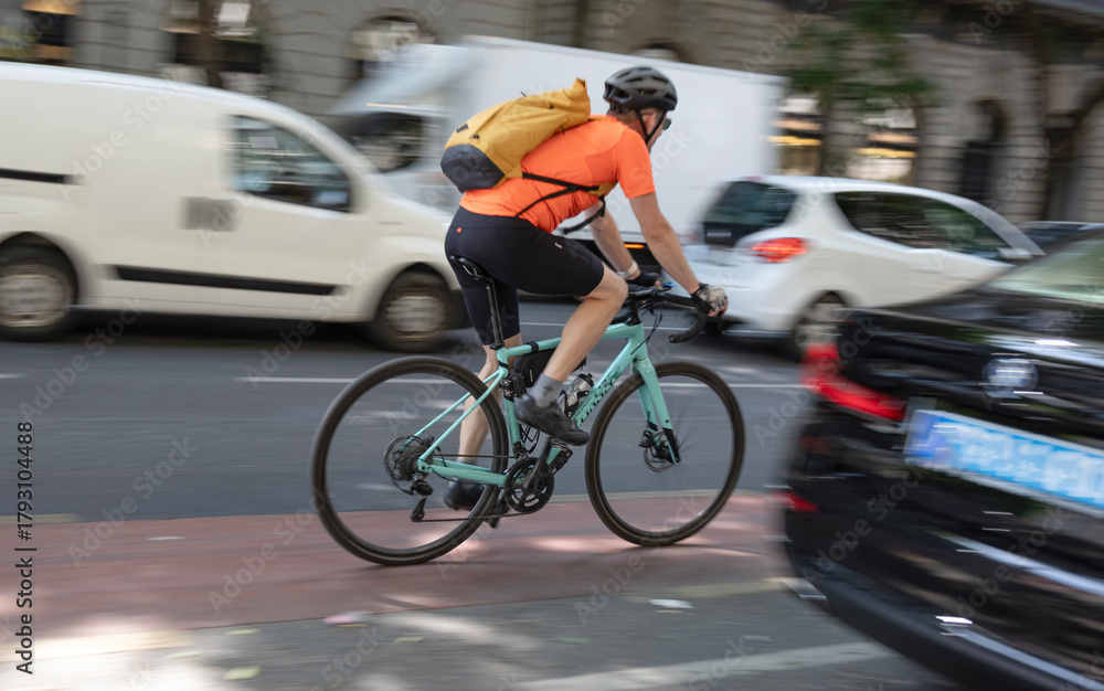 Fototapeta premium Cyclist in motion on busy city street