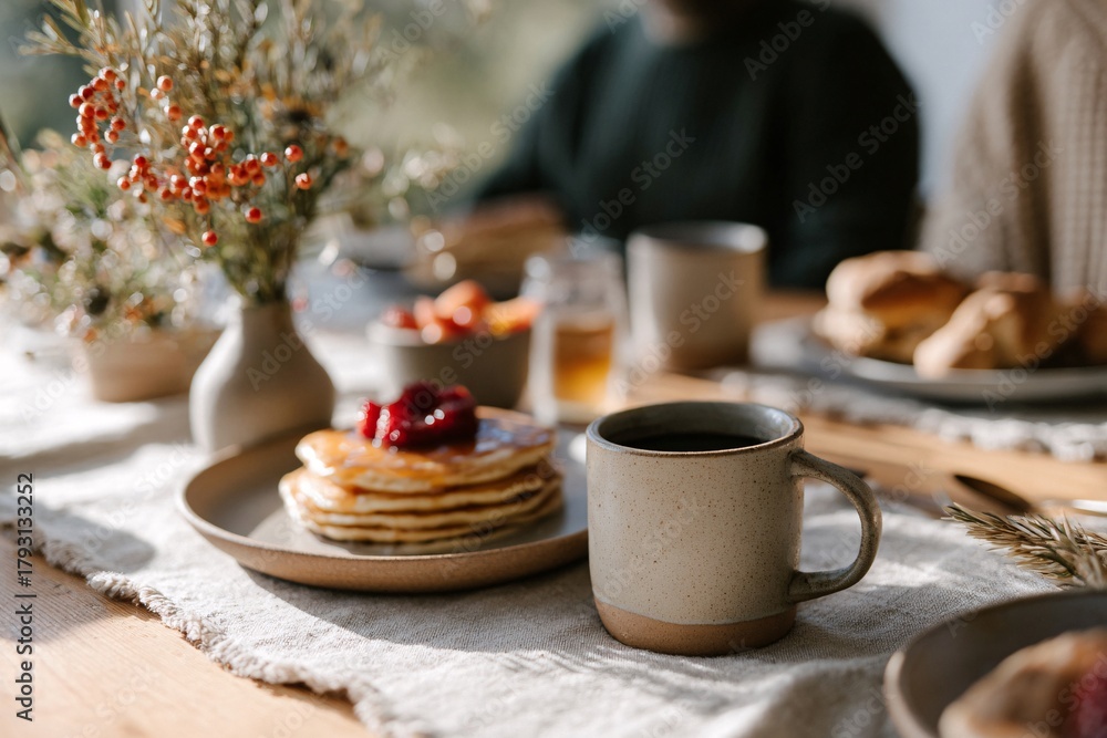 Fototapeta premium Family enjoying breakfast together with pancakes and coffee
