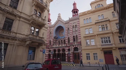 Morning footage of the Jubilee Synagogue’s vibrant Moorish Revival facade, featuring striped patterns, ornate arches, and striking architectural details. Captured in Prague, Czech Republic.
