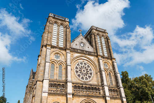 St. Andrew's Church in Bayonne, France, under a bright blue sky.