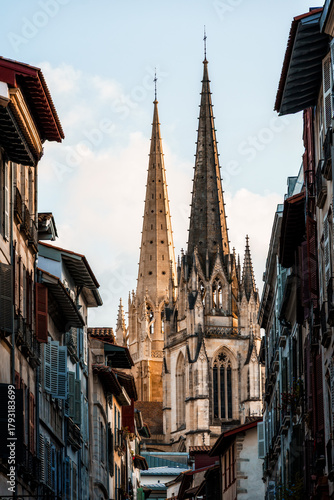 Cathedral of Sainte-Marie in Bayonne, France, framed by historic buildings.