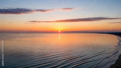Golden hour paints a serene seascape with sun reflecting on calm waters