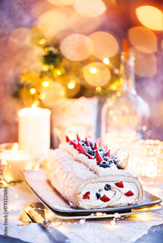 Meringue roll cake with cream and fresh berries