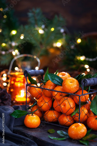 Fresh ripe tangerines with leaves on wooden table