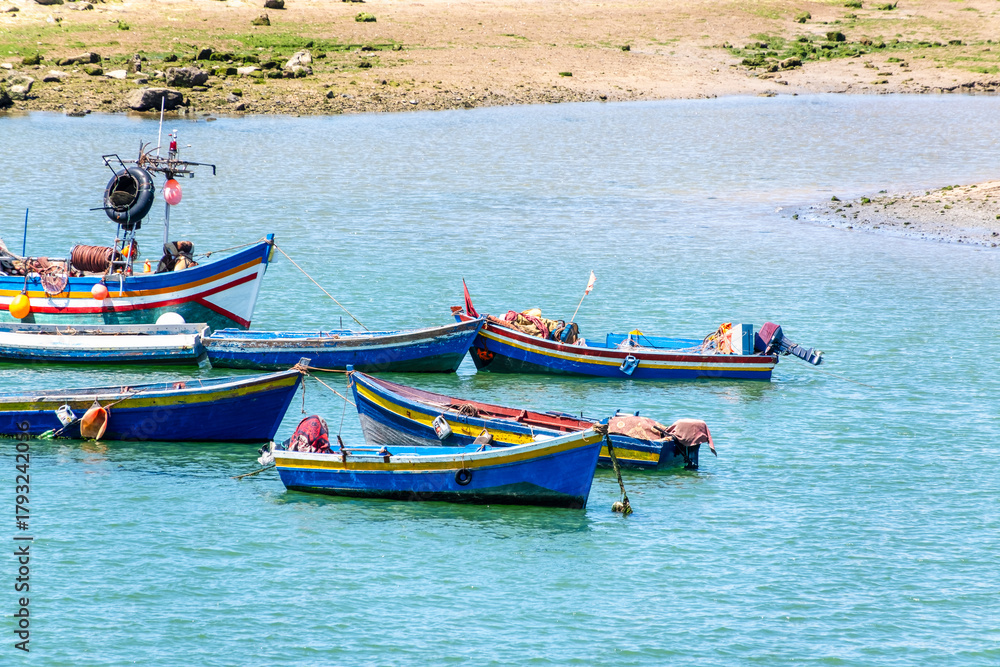 Naklejka premium Rabat, Morocco – A scenic view of the Bou Regreg River with colorful fishing boats gently floating on the water