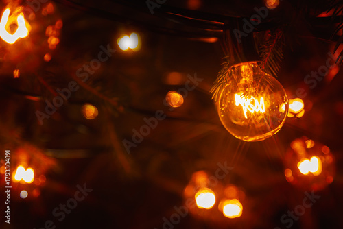 Background - electric garland with incandescent bulbs, yellow warm light