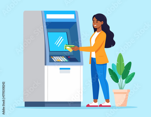 A smiling woman in a yellow jacket inserts a credit card into an ATM machine next to a potted plant.