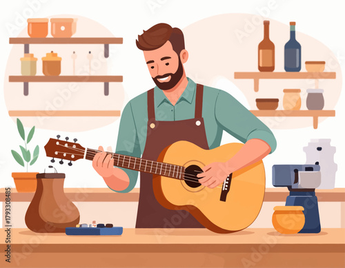 A smiling man with a beard plays an acoustic guitar in a workshop setting with pottery and plants on shelves.