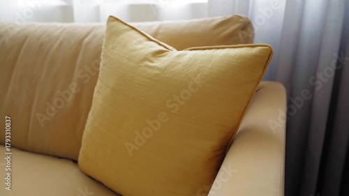Modern yellow sofa with yellow pillow in cozy living room interior