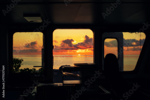 Sunset at sea. Navigation bridge of cargo vessel
