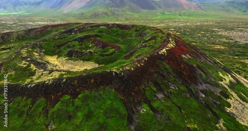 Discover the Ancient Búðaklettur Volcano Through Breathtaking Drone Footage, Revealing Its Dramatic Crater, Lush Green Textures, and the Vast, Otherworldly Landscapes That Define Iceland’s Natural
