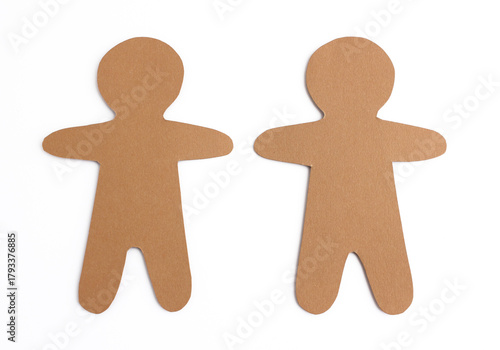 Two gingerbread men hand-cut from brown cardboard isolated