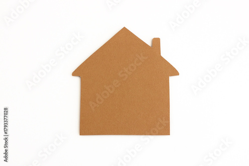 Gingerbread house shape cut from brown cardboard for Christmas decoration, isolated on white