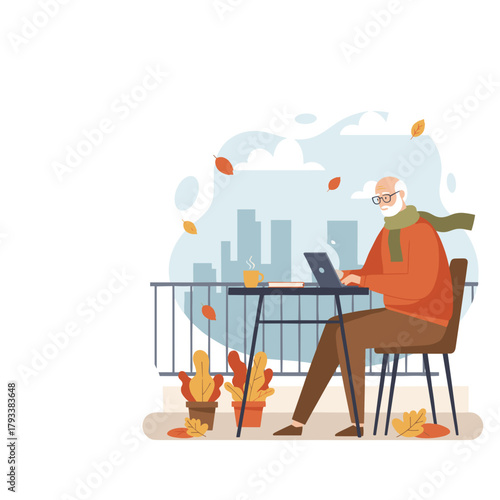 Senior man works on a laptop on a windy autumn balcony overlooking the city skyline