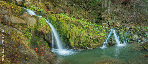 panoramic view to two cascades of waterfall in forest