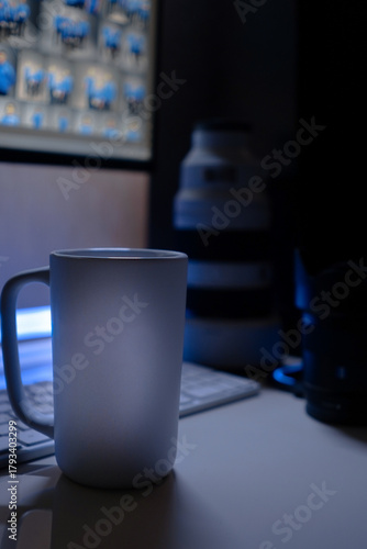 Minimalist workspace with mug / cup and computer keyboard, with Sony Mirrorless Lenses at night. Place for logo at cup / mug