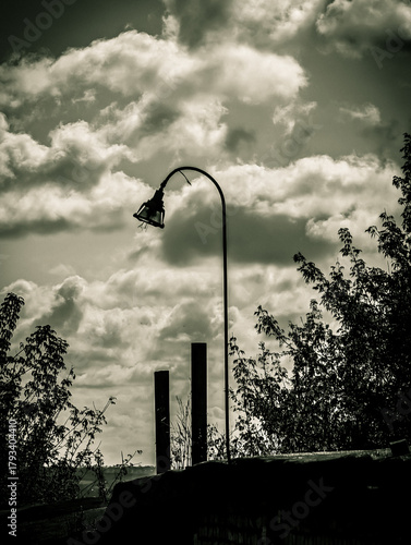 Dramatic Black and White Landscape with Old Lamp and Cloudy Sky