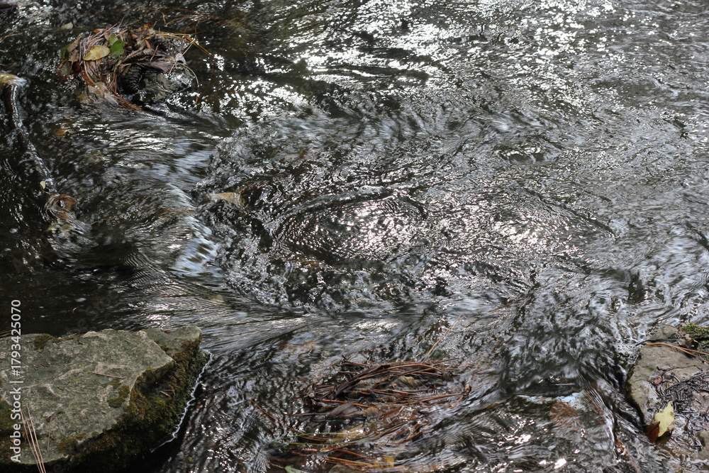 Obraz premium Water currents flowing in the river.