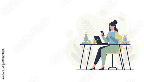 Professional woman using phone and laptop at a desk decorated for the Christmas holiday season