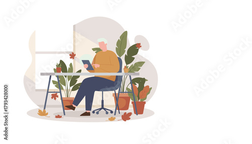 Mature man uses tablet in a green cozy home office environment during autumn