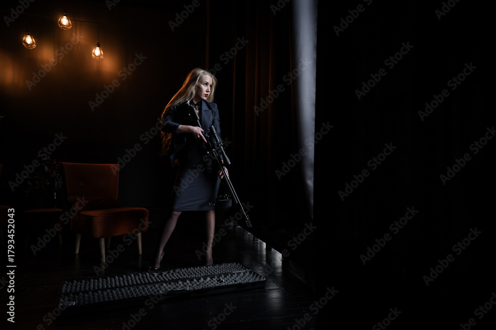 Obraz premium A Caucasian woman in a business suit holds a rifle with a scope. 