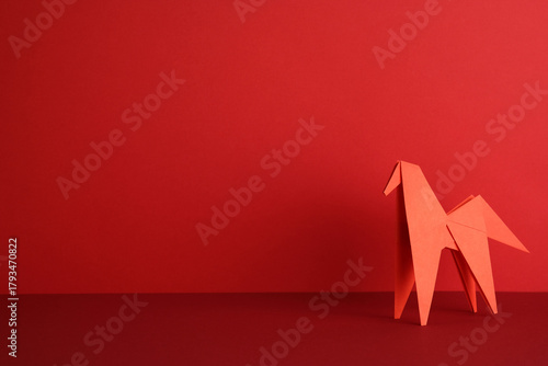 Paper origami horse on red background. Year of the Horse, Chinese New Year concept.