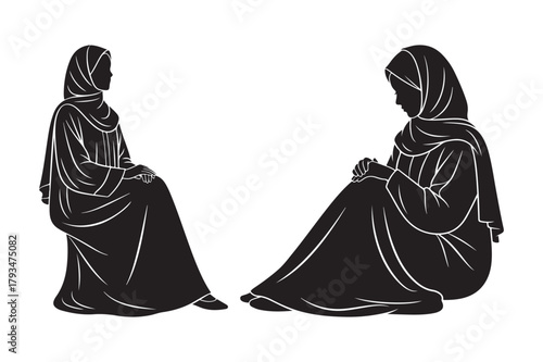 Two silhouetted women in hijabs sitting down