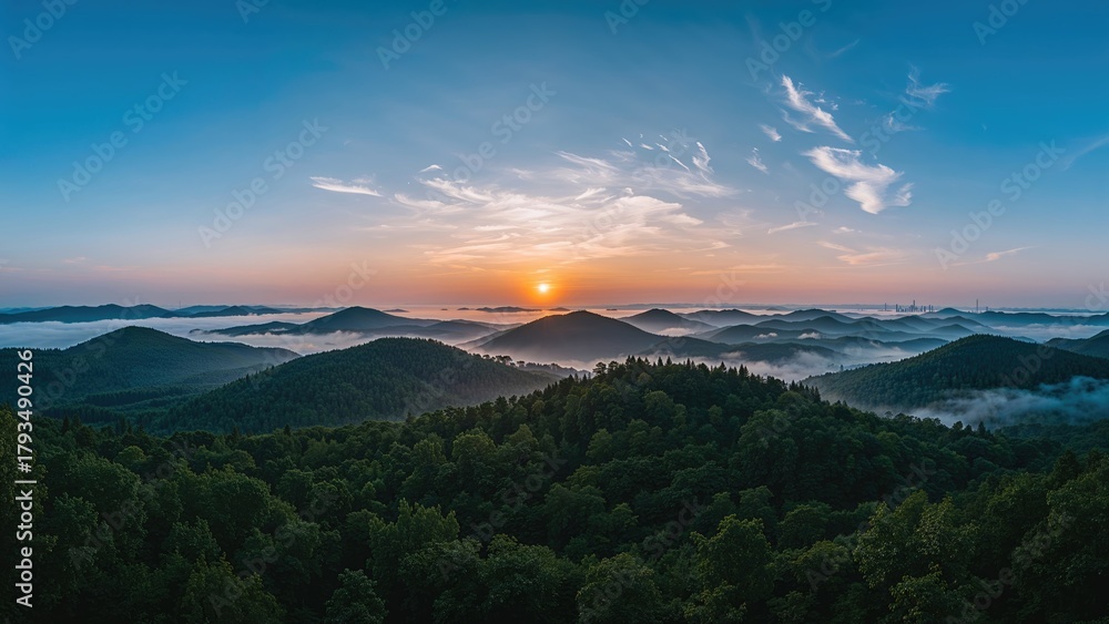 Obraz premium Sunrise over mountainous forests with mist and clouds. Natural landscape and scenery. The beauty of nature and peaceful environment.