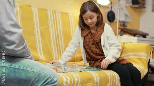 Happy father and child playing board game at home - happiness and family concept.
